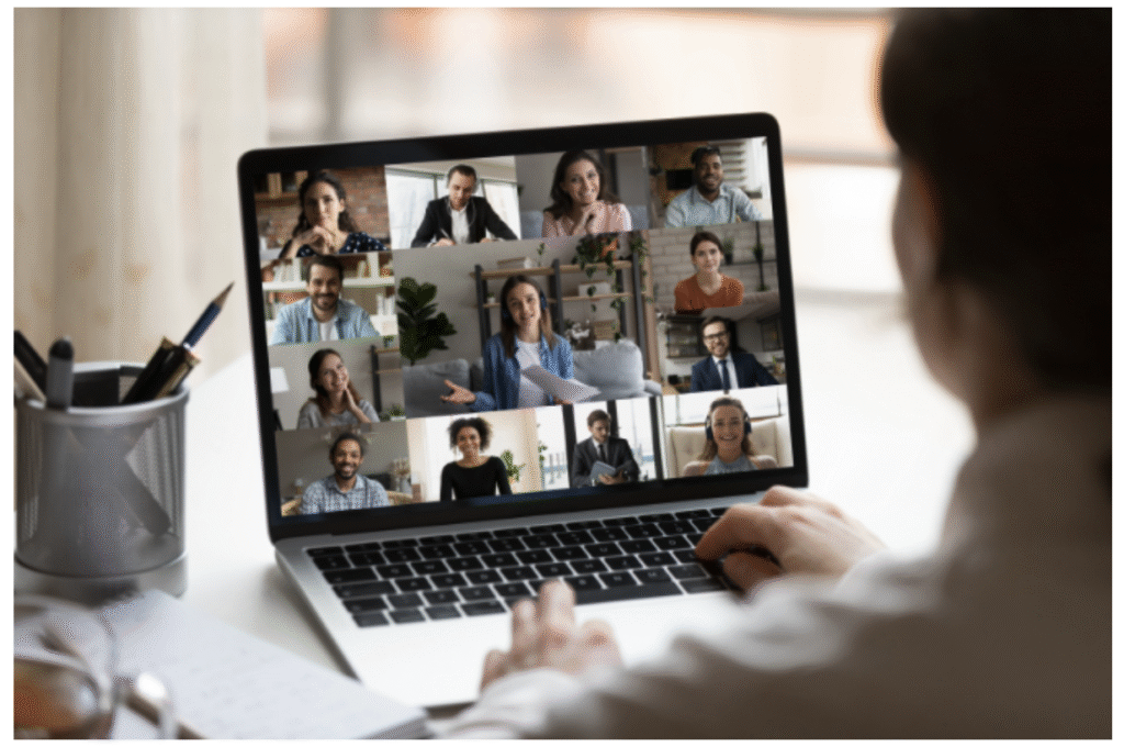 An online meeting, with the images of many people onscreen, including someone who is speaking